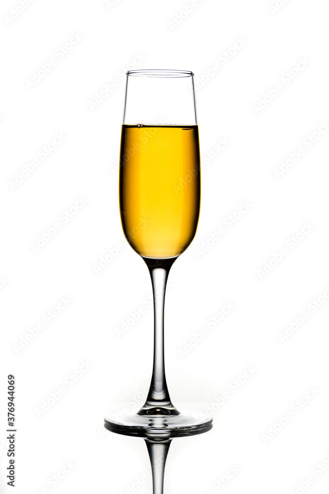 Wine glasses of different shapes with multi-colored drinks on a white background with reflection Wine glasses of different shapes with multi-colored drinks on a white background with reflection