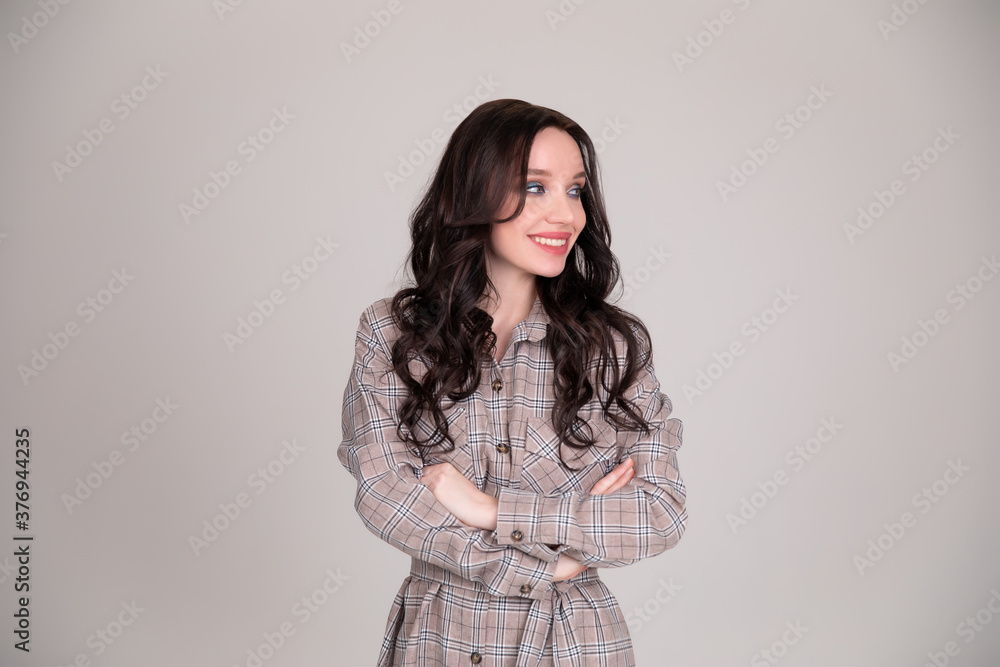 Beautiful girl student, business woman smiles on white, grey background Beautiful girl student, business woman smiles on white, grey background