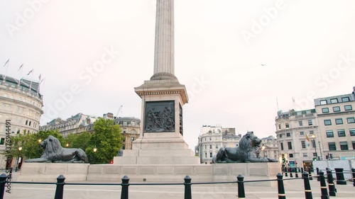 Lockdown in London, Slow motion Gilmbal pan up of Nelson's Column in Empty Trafalgar Square during coronavirus pandemic 2020, empty streets with flying bird.