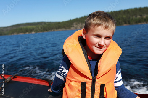 Kid on boat in Ladoga skerries © Arkady Chubykin