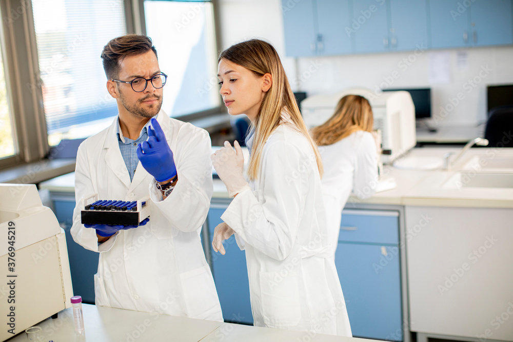 Group of young researchers analyzing chemical data in the laboratory Group of young researchers analyzing chemical data in the laboratory