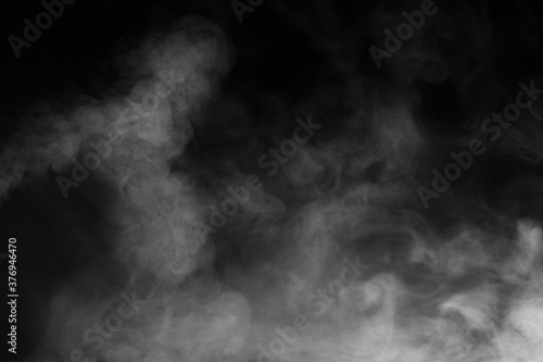 Blur white water vapour on isolated black background. Abstract of steam with copy space. Steam flow. Smoke on white background. 