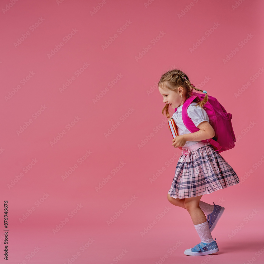 Back to school! Cute hardworking kid in uniform Jogging on pink background. Back to school! Cute hardworking kid in uniform Jogging on pink background.