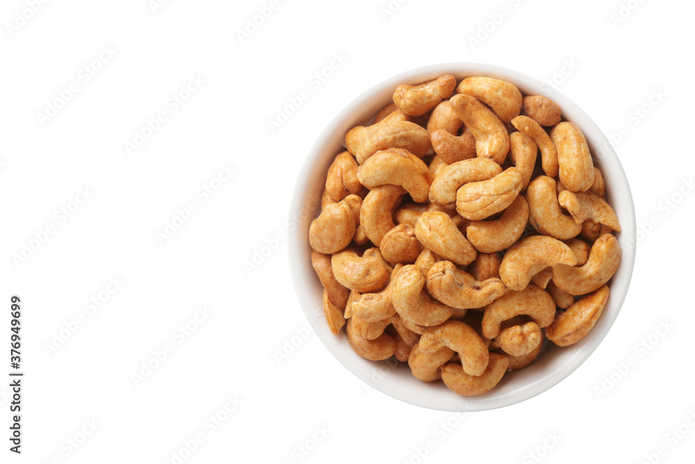 The cashews are in a white cup. Placed on a white background. Food photography concept. Top view. The cashews are in a white cup. Placed on a white background. Food photography concept. Top view.