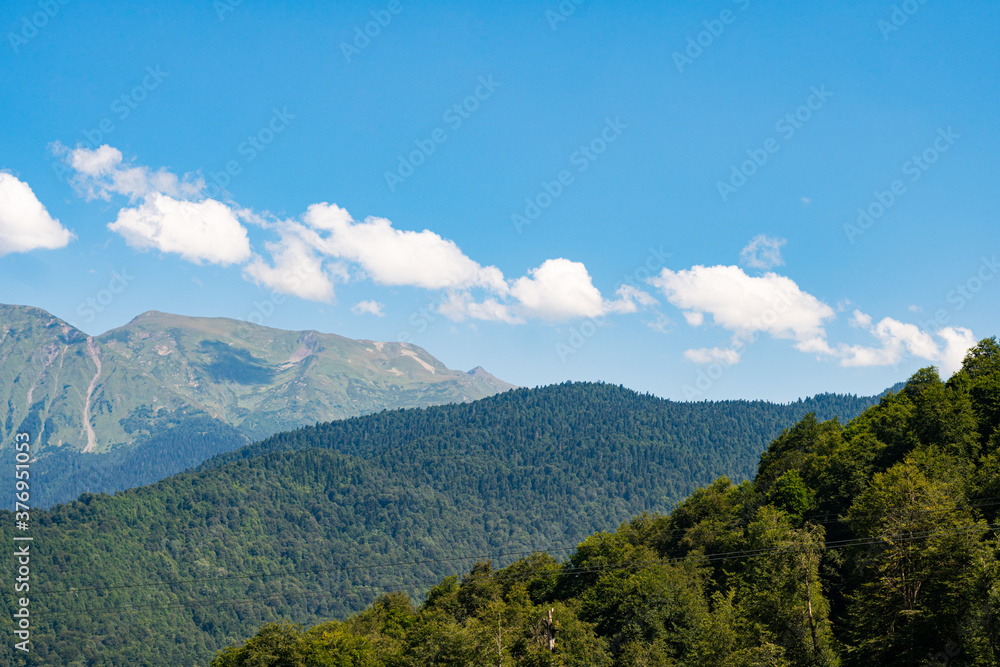 mountain landscape. Green mountains against a blue sky.