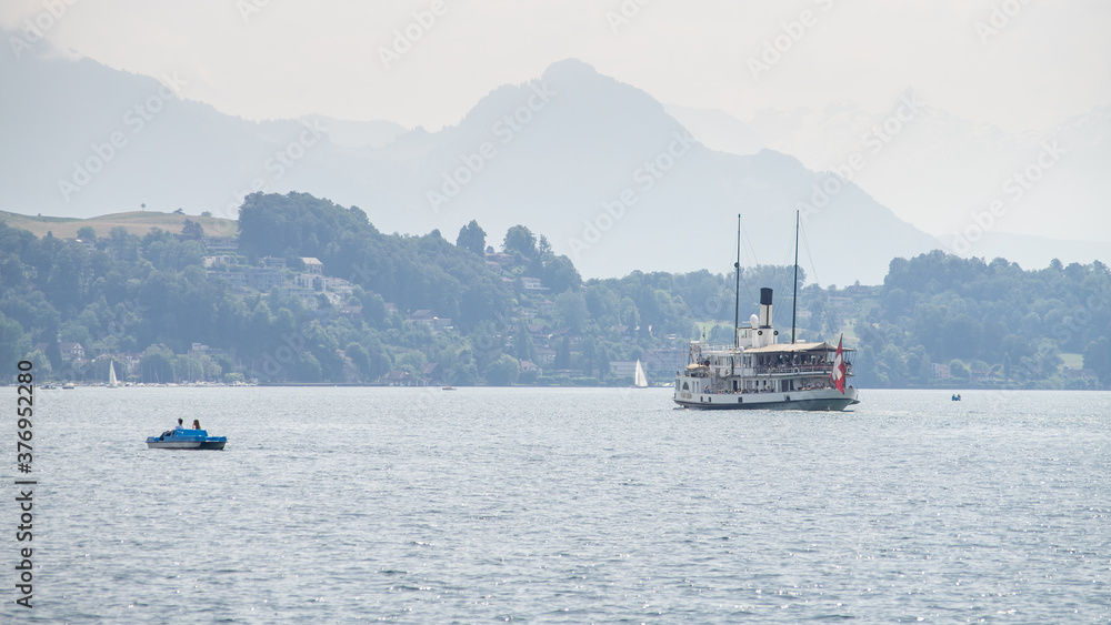 Landscape view on lake Lucerne with steamship and mountains in background. Switzerland. Landscape view on lake Lucerne with steamship and mountains in background. Switzerland.