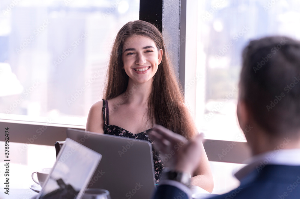 Portrait of smile young woman businessman htalk business deal at skyscraper office lounge with cityscape business zone background Portrait of smile young woman businessman htalk business deal at skyscraper office lounge with cityscape business zone background