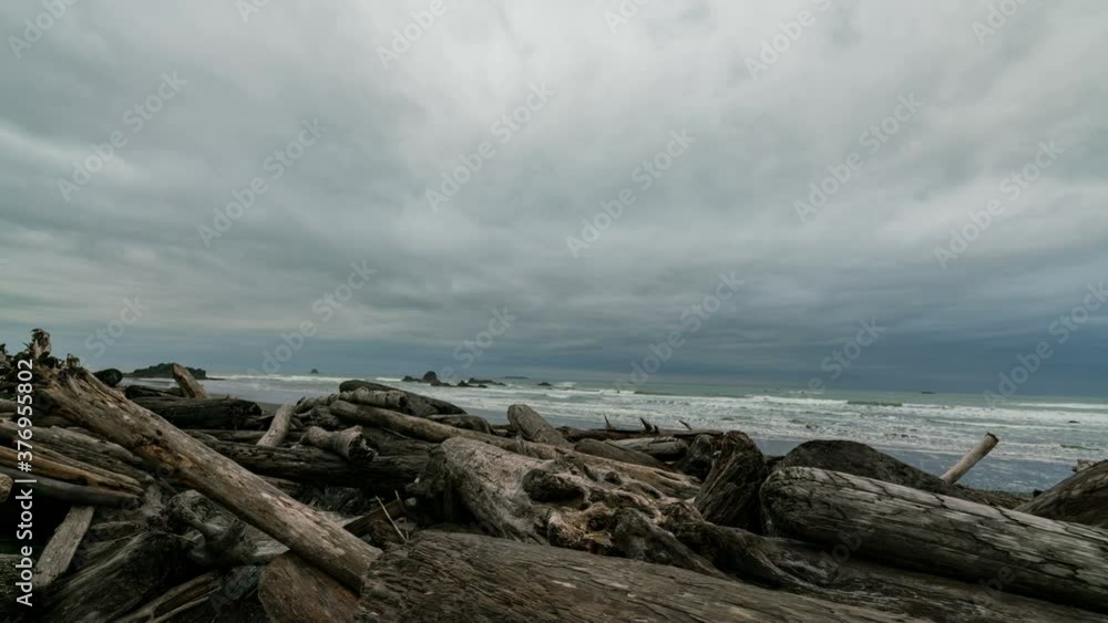 Timelapse tracking shot of moody sky over driftwood at Ruby Beach in Pacific Northwest in Washington State Timelapse tracking shot of moody sky over driftwood at Ruby Beach in Pacific Northwest in Washington State