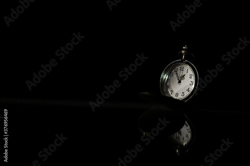 old pocket watch is discarded in the dark. - thinking and control timing ideas concept.