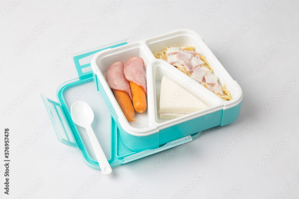Opened tiffin box carrier with food isolated on white Opened tiffin box carrier with food isolated on white