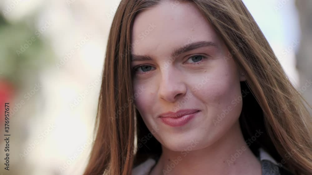 Portrait of a charming smile of a attractive brown-haired woman on a city background. Portrait of a charming smile of a attractive brown-haired woman on a city background.