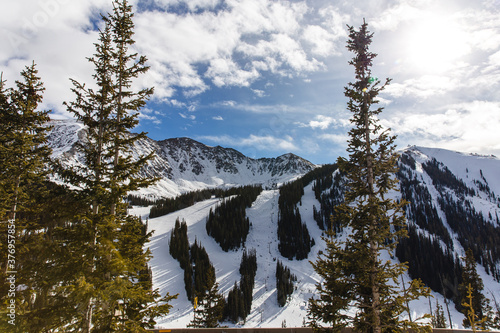 view of a ski resort in the mountains on a nice sunny day in winter photo