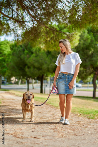 woman walking the dog in the park