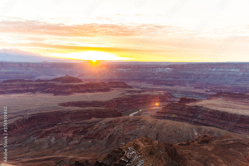 bright sunrise in the american red canyons in summer with a view down