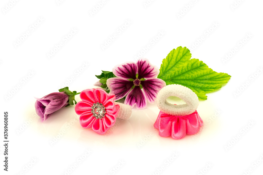 Barrette with pink ribbon and elastic, flowers and green leaf isolated on white background. Barrette with pink ribbon and elastic, flowers and green leaf isolated on white background.