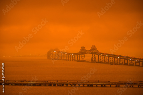 Photography Richmond - San Rafael Bridge in orange smoke and fog from Northern California wi