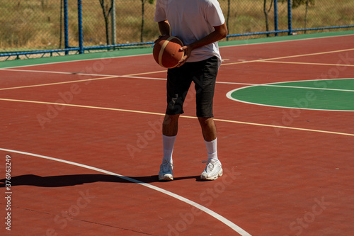 Young man on basketball court dribbling with ball © ErdalIslak