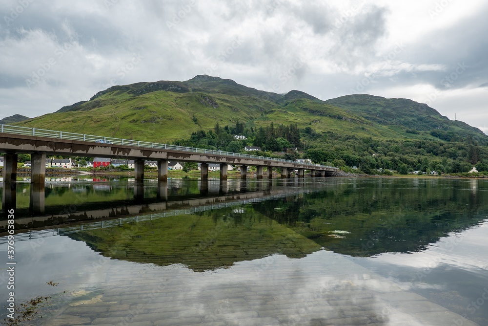 The A87 road bridge above Loch Long in Dornie town in Scotland near the famous Eilean Donan Castle The A87 road bridge above Loch Long in Dornie town in Scotland near the famous Eilean Donan Castle