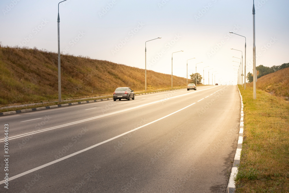 Fototapeta premium car driving on the asphalt road rural landscape