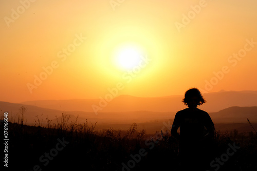 Silhouette of a young man at sunset