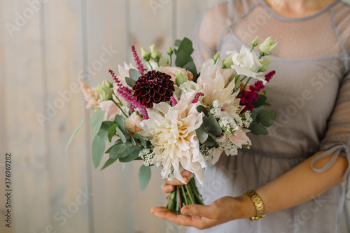 Large Beautiful bouquet of mixed flowers in woman hand. Floral shop concept . Beautiful fresh cut bouquet. Flowers delivery