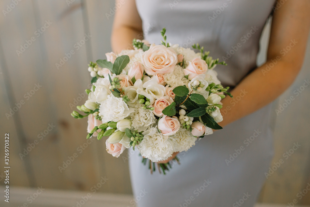 Cheerful young lady with long wavy hair being excited to get bouquet Cheerful young lady with long wavy hair being excited to get bouquet