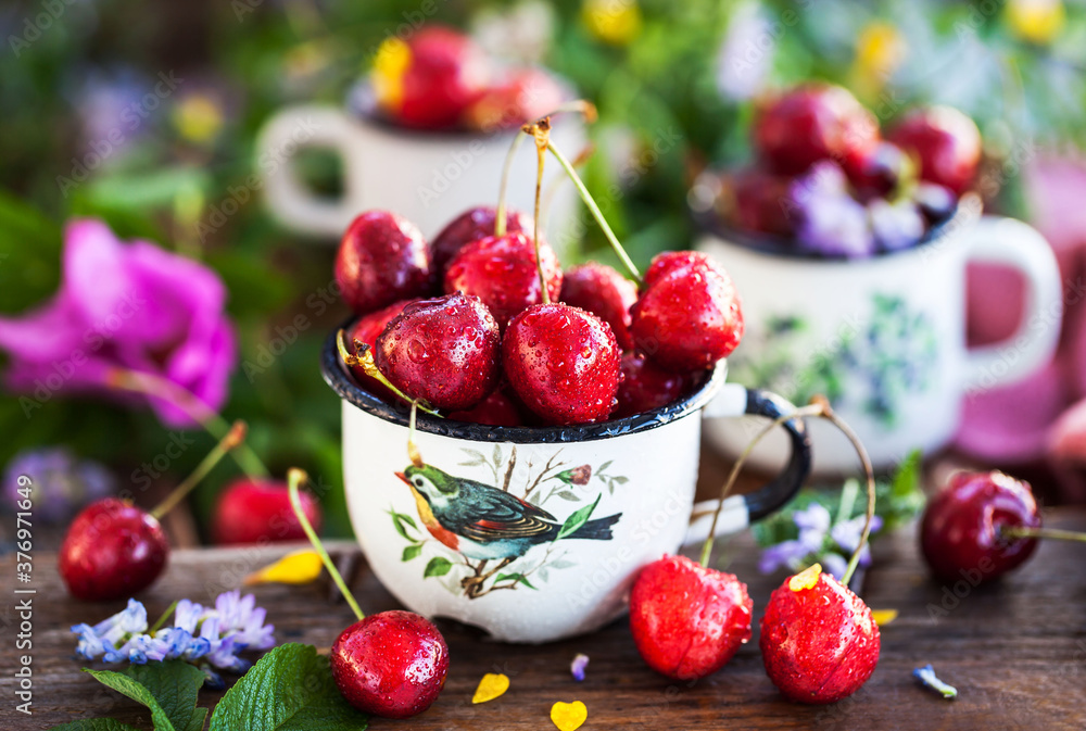 Fresh ripe cherries in a mug on summer background Fresh ripe cherries in a mug on summer background