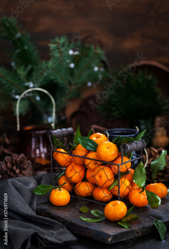 Fresh ripe tangerines with leaves on wooden table