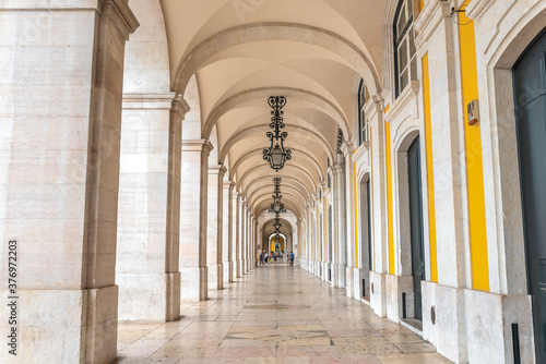 Arcade with beautiful lamps and architectural details in Praca do Comercio, Lisbon - Portugal
