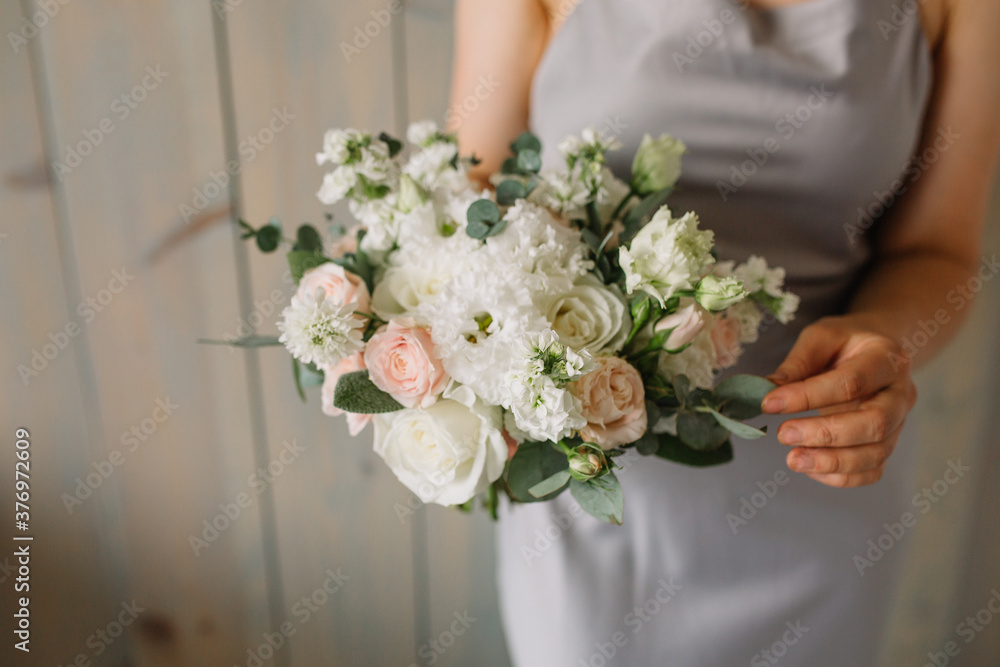 Woman holding in hands big wedding bouquet in rustic style. Woman holding in hands big wedding bouquet in rustic style.