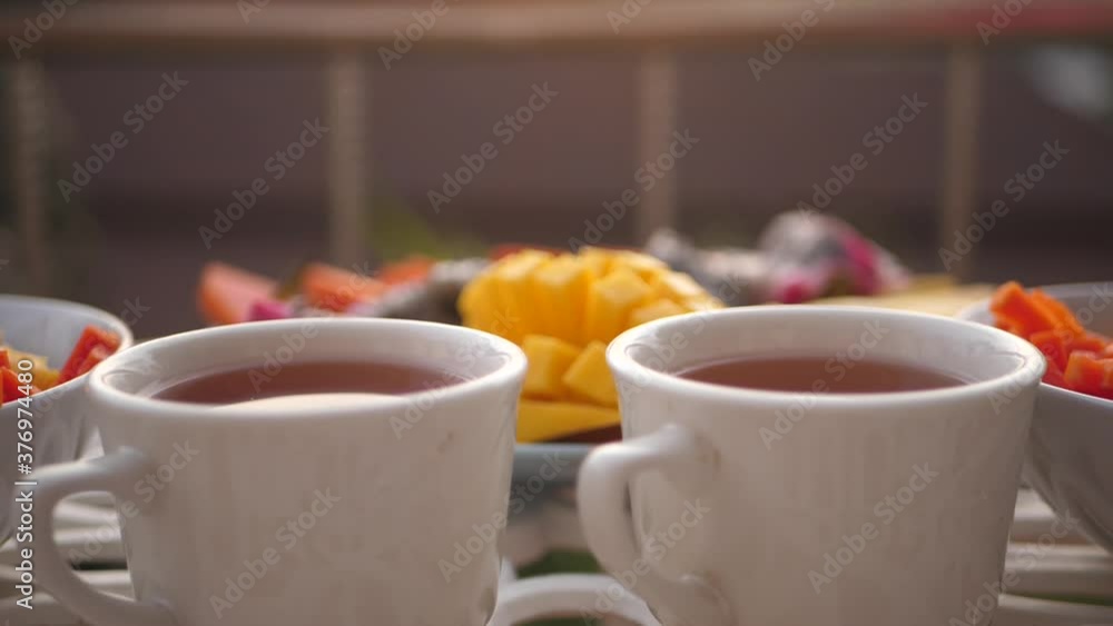 A beautiful breakfast on the table, with invigorating tea and fruit on the plate. 1920x1080. full hd A beautiful breakfast on the table, with invigorating tea and fruit on the plate. 1920x1080. full hd