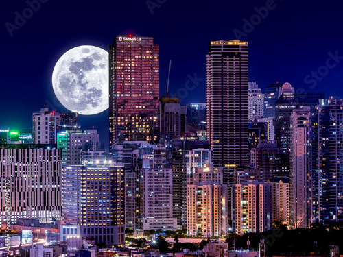 Evening shot of Bonifacio Global City as seen from Makati. Full Moon behind beautiful skyline. photo