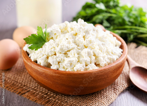 Cottage cheese in a plate on the table, serving cottage cheese. Food photo