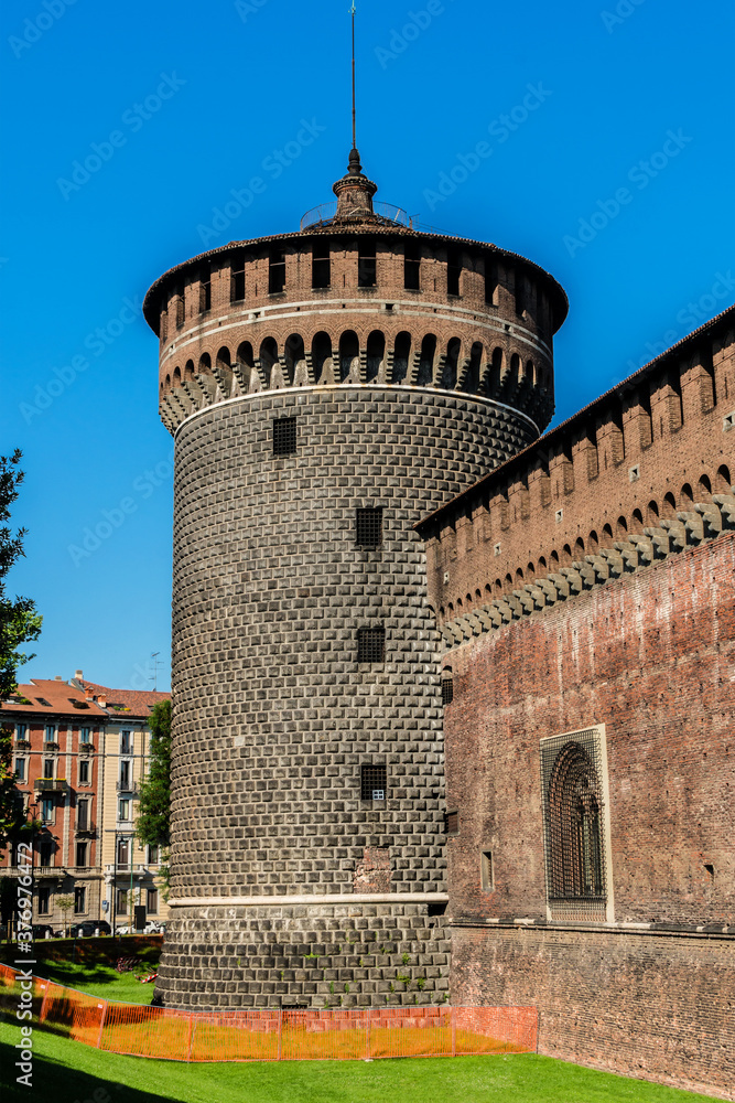 Sforza castle (Castello Sforzesco, XV century) and huge medieval walls in Piazza Castello (Castle square). Milan, Italy.
