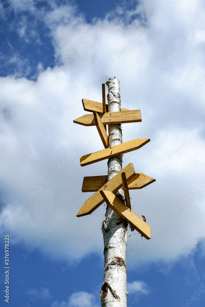 Blank Rustic wooden signpost against blue sky Blank Rustic wooden signpost against blue sky