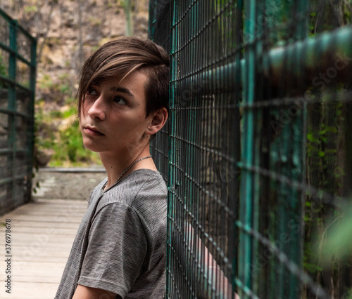 Beautiful boy posing in middle of the suspension bridge.