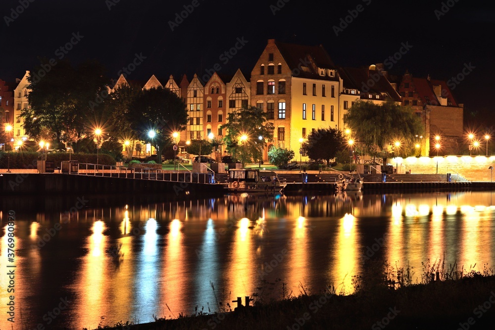 Reflecting lights in the water mirror of the Elbląg Canal at night