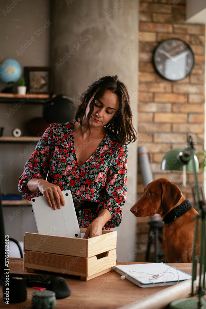 Young businesswoman in office organizing documents. Young woman working in the office. Young businesswoman in office organizing documents. Young woman working in the office.