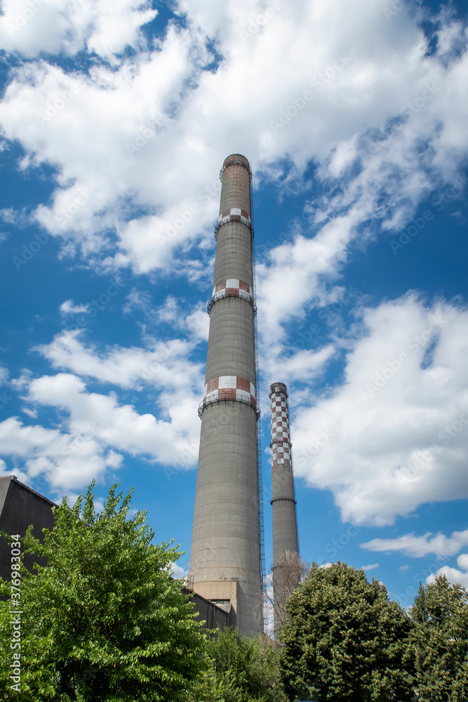 brick industrial chimney at the cloudy sky. Industry concept image. Old factory, ecology, industrial renewal, globalization. brick industrial chimney at the cloudy sky. Industry concept image. Old factory, ecology, industrial renewal, globalization.