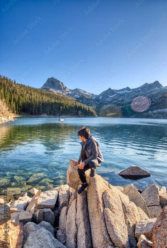 Boy overlooking a river on a Sierras, California adventure Boy overlooking a river on a Sierras, California adventure