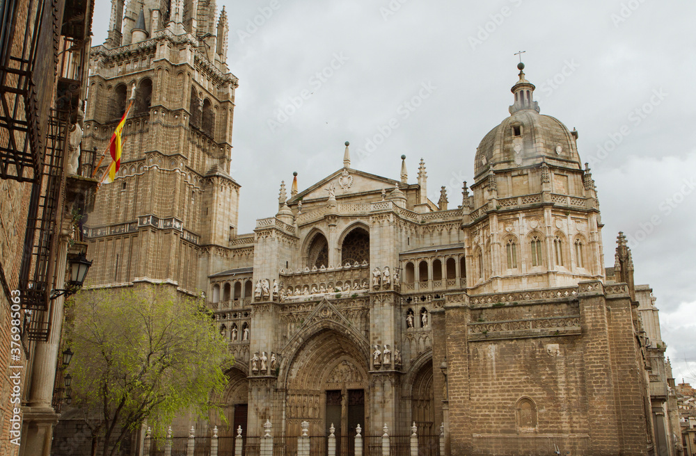 Ancient architecture and design. Gothic style. View of the The Primate Cathedral of Saint Mary of Toledo facade and tower, in Spain. 