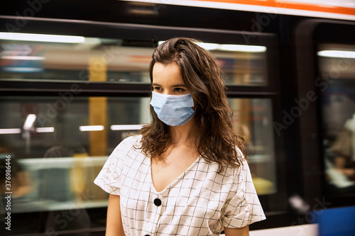 Young girl wearing a face mask in the subway