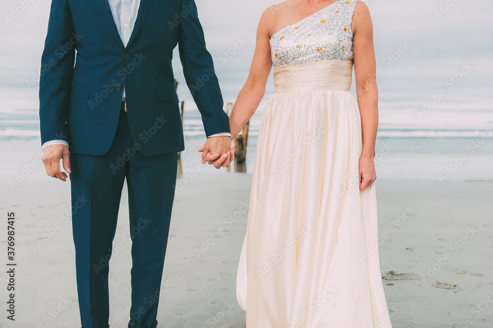 Newlyweds Holding Hands Beach Wedding Newlyweds Holding Hands Beach Wedding