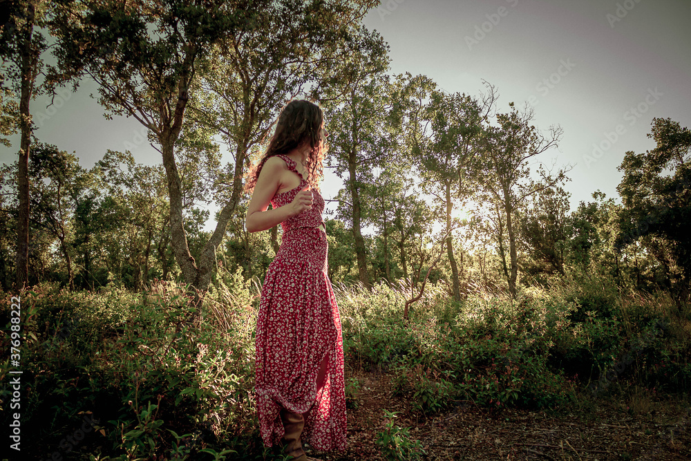 young woman in the middle of a forest in long summer dress young woman in the middle of a forest in long summer dress