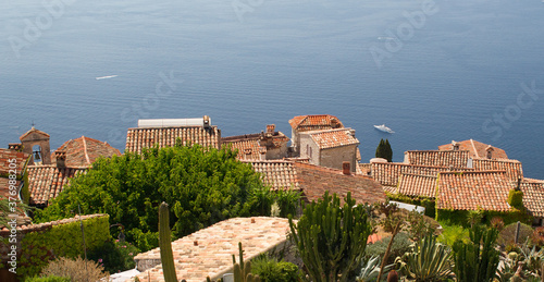 Aerial view on "Eze" city terracotta rooftops and blue mediterranean sea