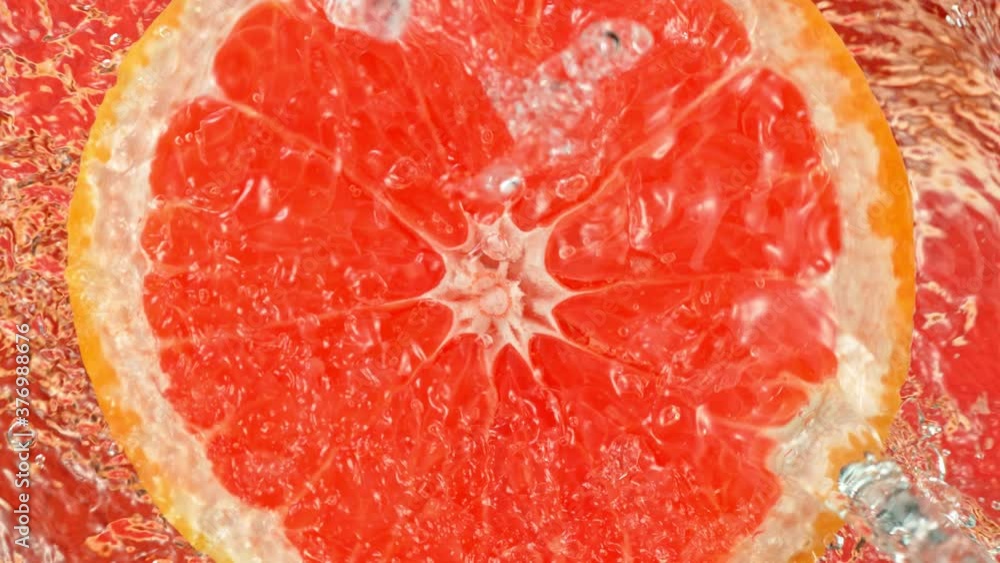 Super Slow Motion Shot of Splashing Water on Rotating Grapefruit Slice at 1000fps. Super Slow Motion Shot of Splashing Water on Rotating Grapefruit Slice at 1000fps.