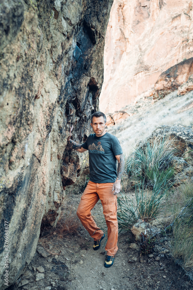 Male climber is getting ready to boulder in Smith Rock park in Oregon