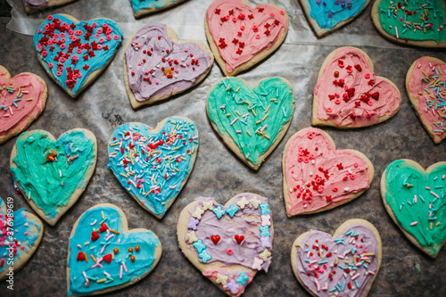 Colorful heart shaped valentines cookies with sprinkles photo