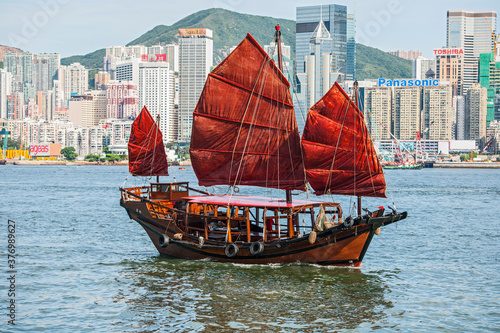 traditional junk boat at Victoria Harbour in Hong Kong photo