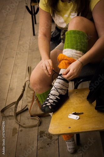 The girl ties shoes for Irish dancing